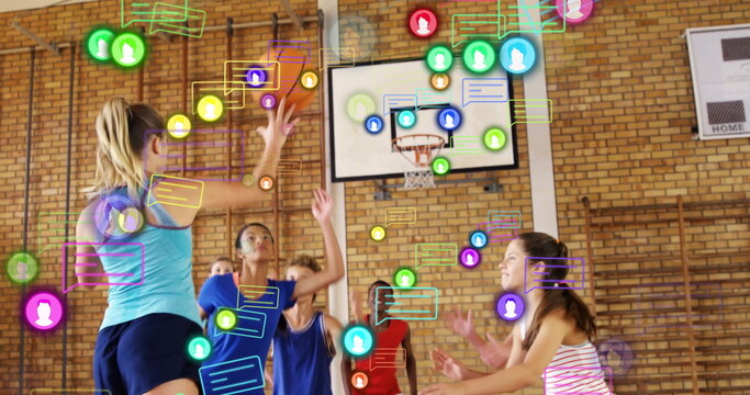 Jumping athlete in turquoise top shooting basketball at school gym with media icons, copy space