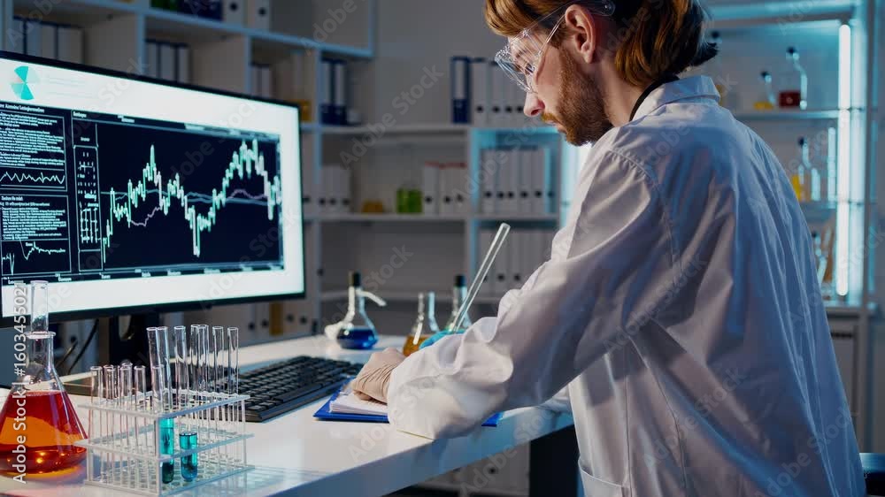 Poster scientist in a lab coat analyzes data on a computer screen with colorful chemicals around. side angl
