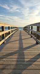 Fototapeta premium Wooden walkway bridge leading to the ocean