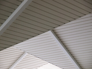 Obraz premium Layer or stacked of white ceilings with pvc plastic panels cladding with strips pattern.