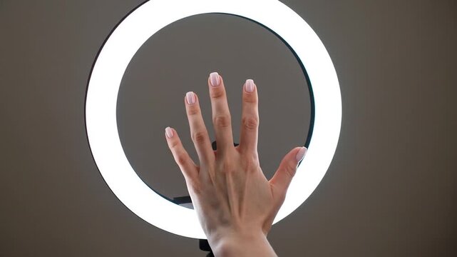 Hand Reaching Under Ring Light, Close-up Beauty Shot