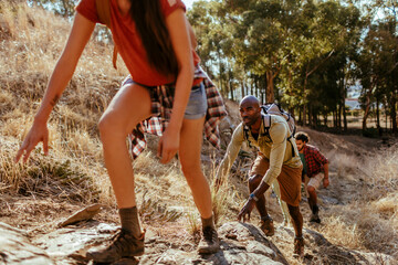 Young and diverse group of friends and hikers hiking together in the mountains of south africa