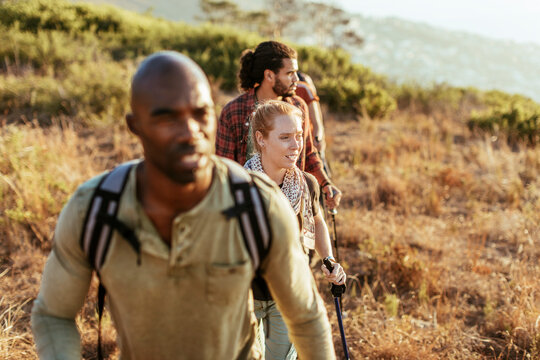 Young and diverse group of friends and hikers hiking together in the mountains of south africa - Powered by Adobe