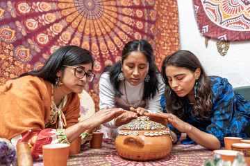 Women performing organic cocoa ceremony for alternative medicine and healthy living