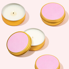 Aroma soy wax candles in a metal jar. Modern Colorful pattern with scented candles in a metal can. Pink candles for cozy atmosphere and aromatherapy. Trendy pastel colors. Wellness and spa concept