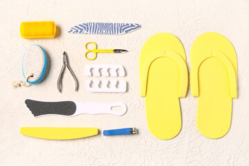 Set of professional tools for pedicure on textured white background