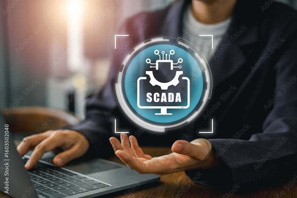 Poster engineer interacts with scada system on laptop, showcasing industrial automation and control technol