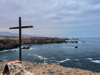A big cross over spectacular view of cliffs of Pacific ocean,  view point next to Mollendo in southern Peru. It is located in the Arequipa Region and is the capital of both the Islay Province 
