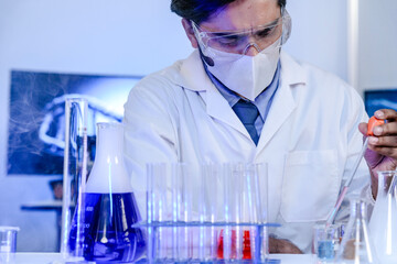 A dedicated Indian researcher analyzes a biological sample in a lab, contributing to medical...