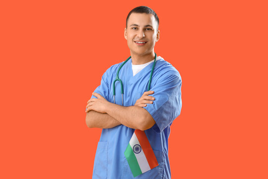 Male nurse with flag of India on orange background. National Doctor's Day celebration