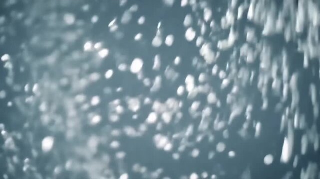 Magical slow motion of silver and white confetti falling like snow.