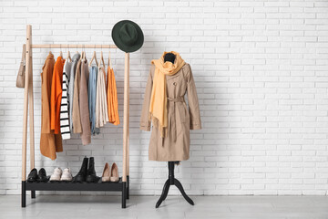 Rack with clothes and accessories in interior of modern room