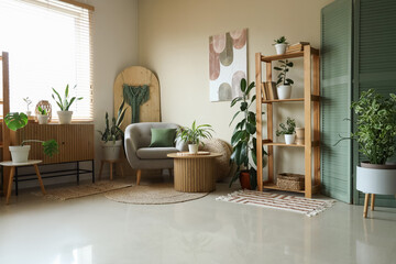 Interior of living room with green houseplants, armchair and shelf unit