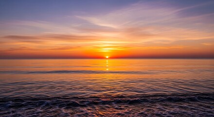 Obraz premium Captivating sunrise over the ocean, showcasing vibrant colors in the sky and reflecting on