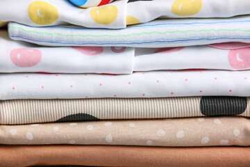 Stack of different baby clothes, closeup
