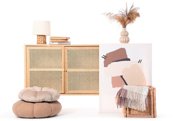 Chest of drawers with lamp, books and decor on white background