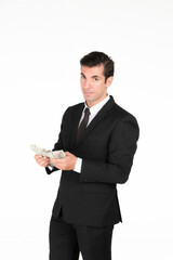 Half-body headshot serious yet confident businessman holds money, symbolizing the rewards of hard work, investment, and financial acumen studio on white background.