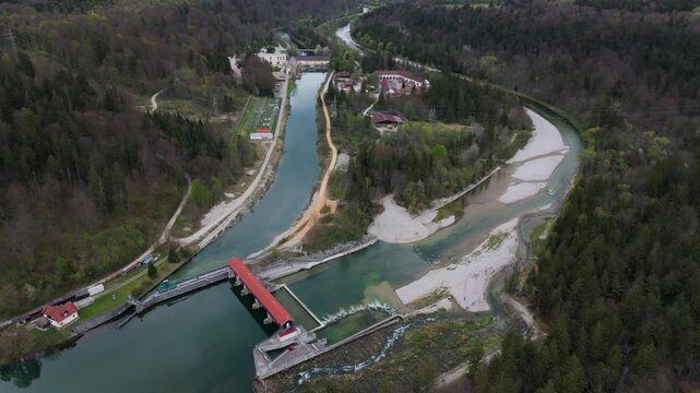 Scenic aerial shot of the Baierbrunn hydropower station, Isarwerkkanal, and fish ladder in Bavaria, Germany. Modern VLH turbine, eco-friendly electricity production, flood control, and nature. 