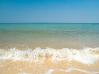 Photography peaceful tropical sea beach with soft white sand, turquoise sea, and small island in distance under bright blue sky with fluffy clouds. scene for summer vacation travel and relaxation.