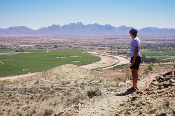 Lone hiker stands on a hiking trail in the Prehistoric Trackways National Monument on the Robledo...
