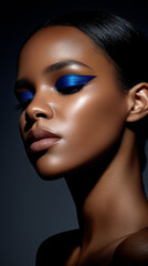 black woman fashion model with bright blue eyeshadow dramatic smooth hair neutral lipstick dark background makeup brand marketing social media post branding cosmetics