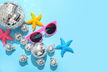Disco balls with sunglasses and starfishes on blue background