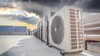 Air conditioning HVAC on the roof of an industrial building with blue sky and clouds