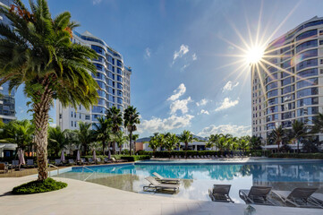 Resort‑Style Pool with Palm Trees and High‑Rise Skyline