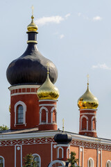 Golden and black onion domes of Voskresensky Cathedral in Staraya Russa, Russia, illuminated by...