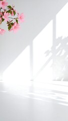Soft pink flower shadows cast on plain white wall in natural light, clean minimal