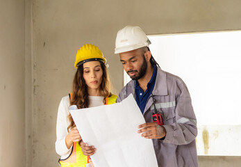Professional architect and foreman two person wear head hat talk meeting safety work team 
check...