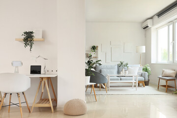 Interior of living room with sofa, floor lamp and workplace