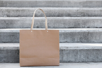 Paper bag on stairs outdoors. Food delivery service