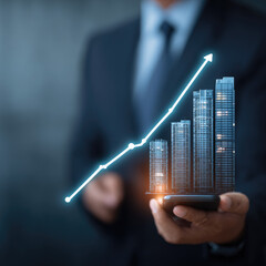 Business growth, depicted by rising graph and buildings on a phone
