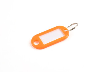 Orange plastic key tag isolated on white background