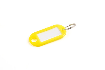 Yellow plastic key tag isolated on white background