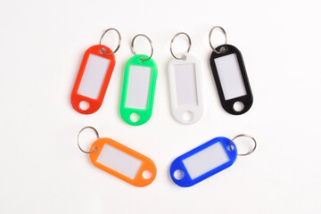 Colorful plastic key tag isolated on white background. Top view, Flat lay