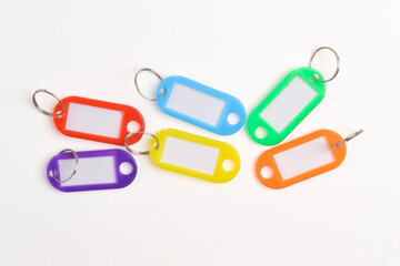 Colorful plastic key tag isolated on white background. Top view, Flat lay
