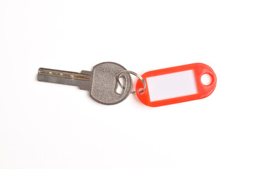 Key with blank red plastic tag isolated on white background