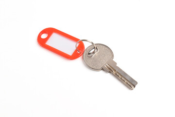 Key with blank red plastic tag isolated on white background