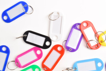 Colorful plastic key tag isolated on white background. Top view, flay lay