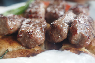 Delicious grilled meat skewers served with bread