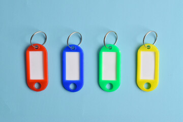 Colorful plastic key tag isolated on light blue background