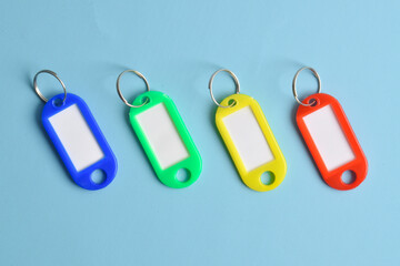 Colorful plastic key tag isolated on light blue background