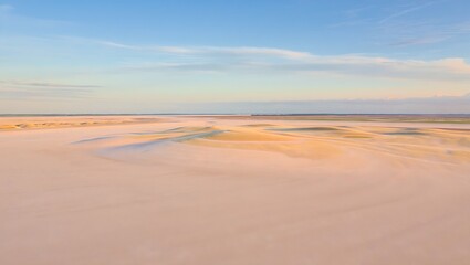 Fototapeta premium Scenic Sand Dune Landscape with Blue Sky, Golden Hour, and Natural Beauty