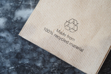 Recycled material napkin on a dark surface