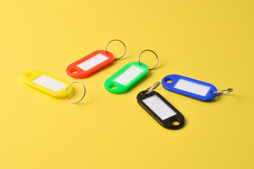 Colorful plastic key tag isolated on yellow background