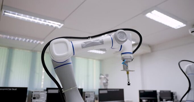 Collaborative robot or cobot with suction gripper operates on smart table during automation training inside robotics lab for industry 4.0 demonstration in modern engineering education center