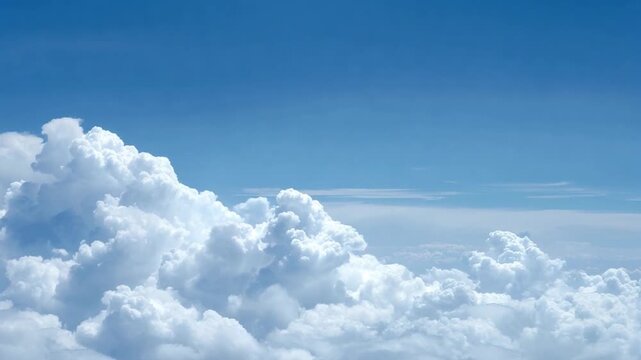 Cumulus Clouds in Azure Sky: Majestic cumulus clouds drift serenely against a backdrop of a clear, azure sky, evoking a sense of peace and the vastness of the atmosphere.