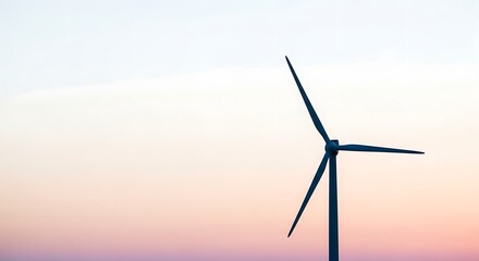 Fototapeta premium Wind turbine against a pastel sky at dusk generating clean sustainable alternative energy source
